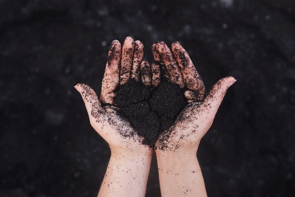 hands-hold-dirt-shaped-in-heart-form